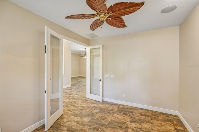 spare room featuring ceiling fan and french doors