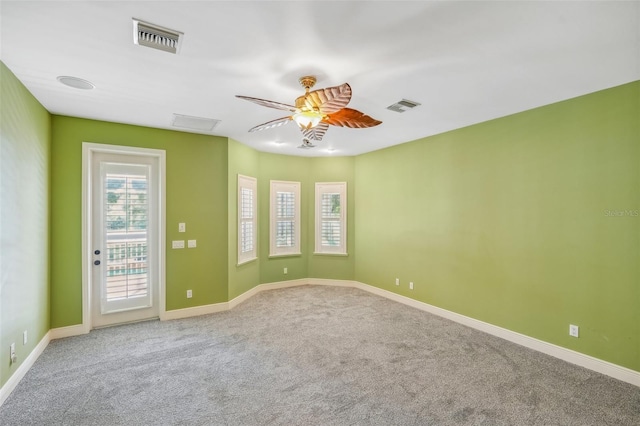 unfurnished room with ceiling fan and carpet