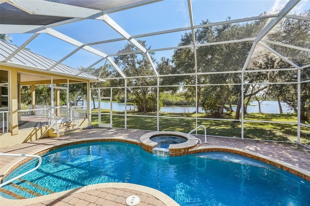 view of pool with a lanai, a patio, a water view, and an in ground hot tub