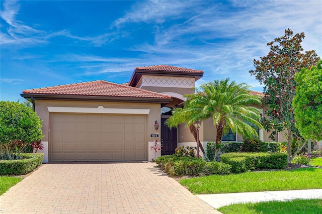 mediterranean / spanish-style house with a garage