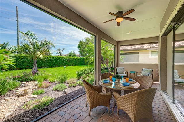 sunroom / solarium featuring ceiling fan