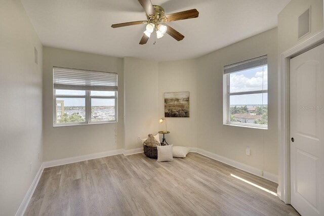 unfurnished room featuring ceiling fan and light hardwood / wood-style flooring