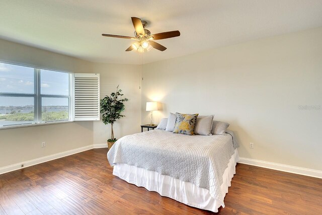 bedroom with ceiling fan and dark wood-type flooring