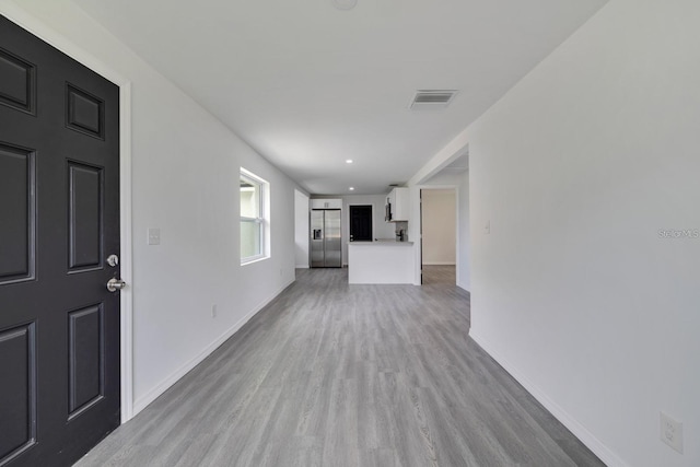 unfurnished living room featuring light hardwood / wood-style floors