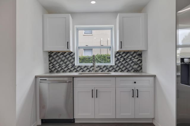 kitchen with white cabinetry, sink, backsplash, and dishwasher