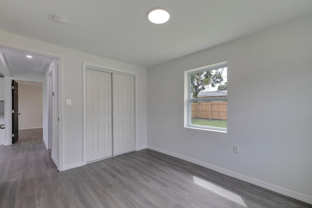 unfurnished bedroom with hardwood / wood-style flooring and a closet