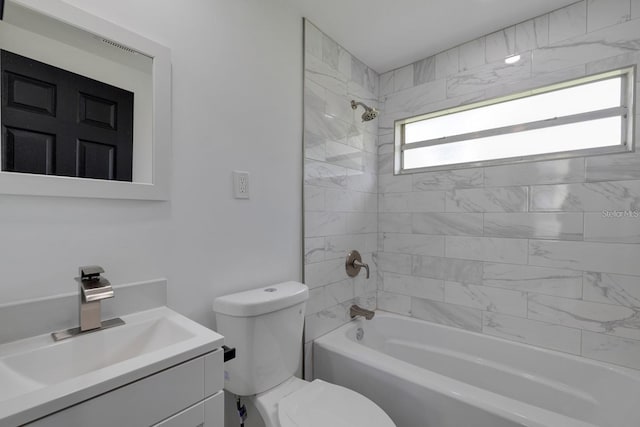 full bathroom with vanity, toilet, and tiled shower / bath combo