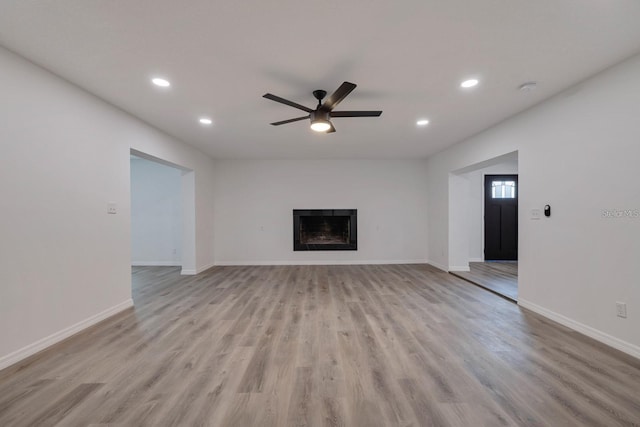 unfurnished living room with ceiling fan and light hardwood / wood-style floors