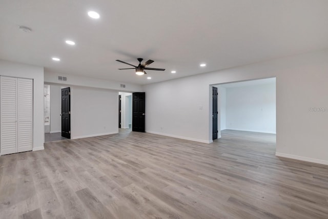 unfurnished living room with ceiling fan and light wood-type flooring