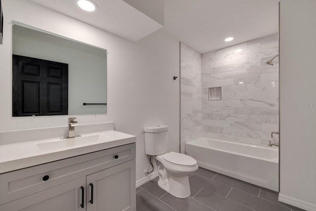 full bathroom featuring vanity, toilet, and tiled shower / bath