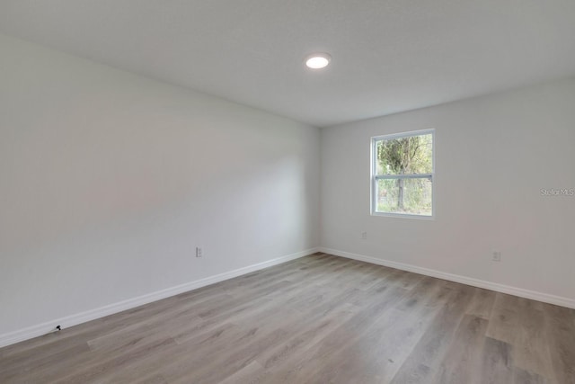 unfurnished room with light hardwood / wood-style floors