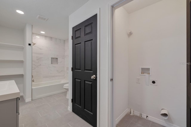 washroom featuring hookup for a washing machine, hookup for an electric dryer, and light tile patterned floors