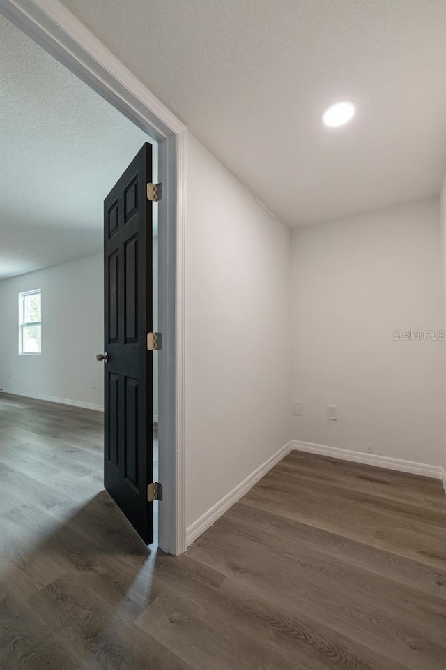 hallway featuring dark wood-type flooring