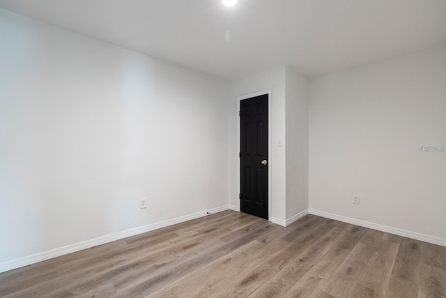 spare room featuring light hardwood / wood-style floors