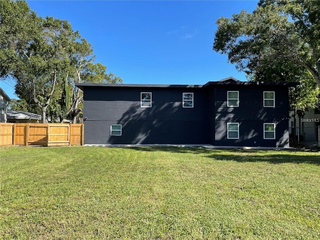 rear view of property with a yard