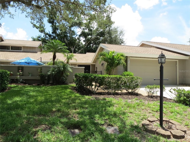 view of front of house featuring a front yard and a garage