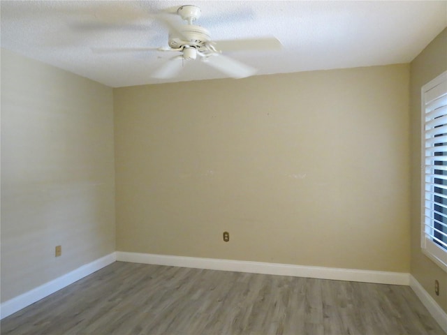 spare room featuring hardwood / wood-style flooring and ceiling fan