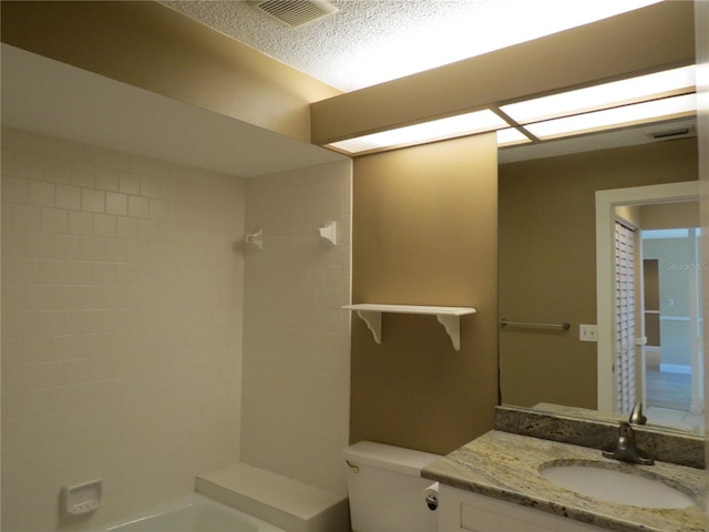 full bathroom with vanity, toilet, visible vents, and a textured ceiling