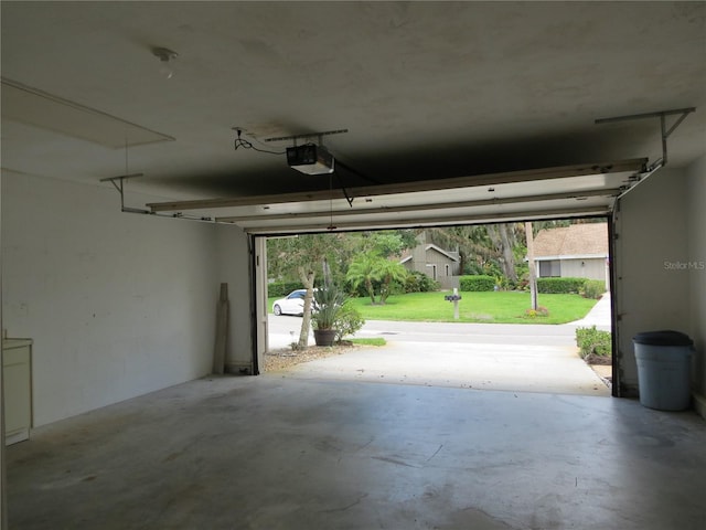 garage featuring a yard and a garage door opener