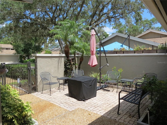 view of patio featuring fence