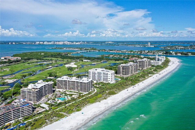 birds eye view of property with a beach view and a water view