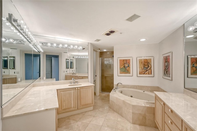 bathroom featuring vanity, independent shower and bath, and tile patterned floors