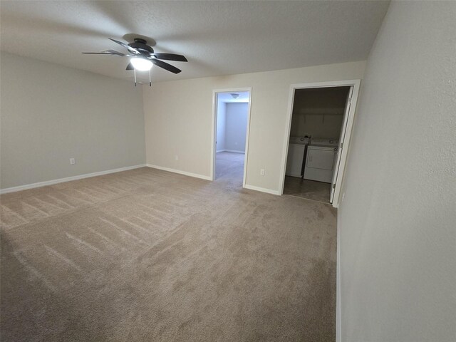 empty room with carpet flooring, washer and dryer, ceiling fan, and a textured ceiling