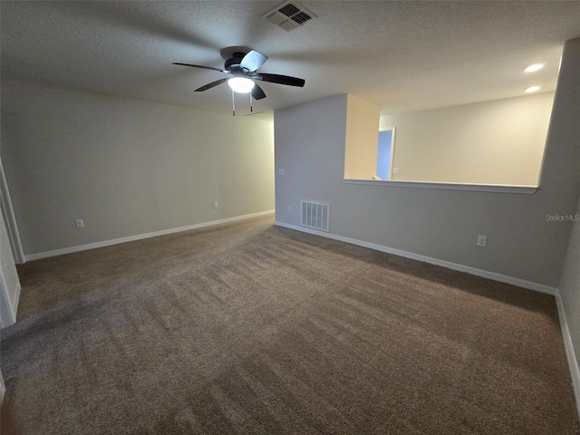 carpeted empty room with ceiling fan and a textured ceiling