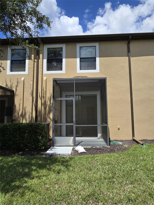 rear view of house with a lawn