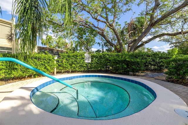 view of pool with an in ground hot tub