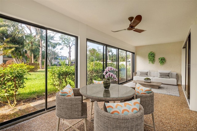 sunroom featuring ceiling fan