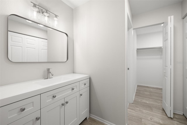 bathroom with hardwood / wood-style floors and vanity