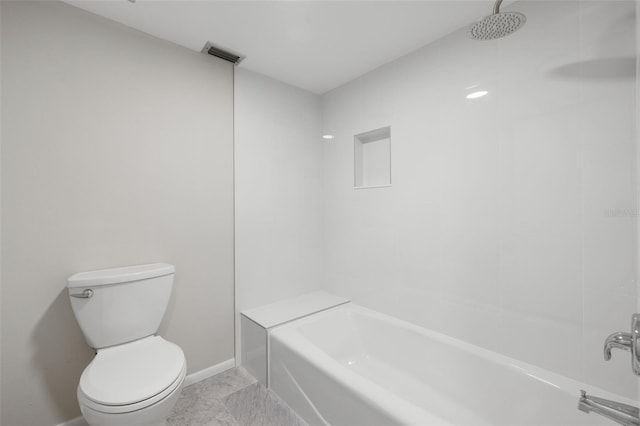 bathroom featuring tile patterned floors, tub / shower combination, and toilet