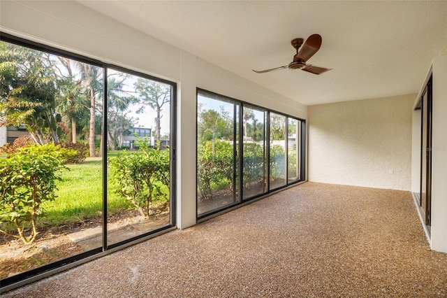 unfurnished sunroom with ceiling fan and a healthy amount of sunlight