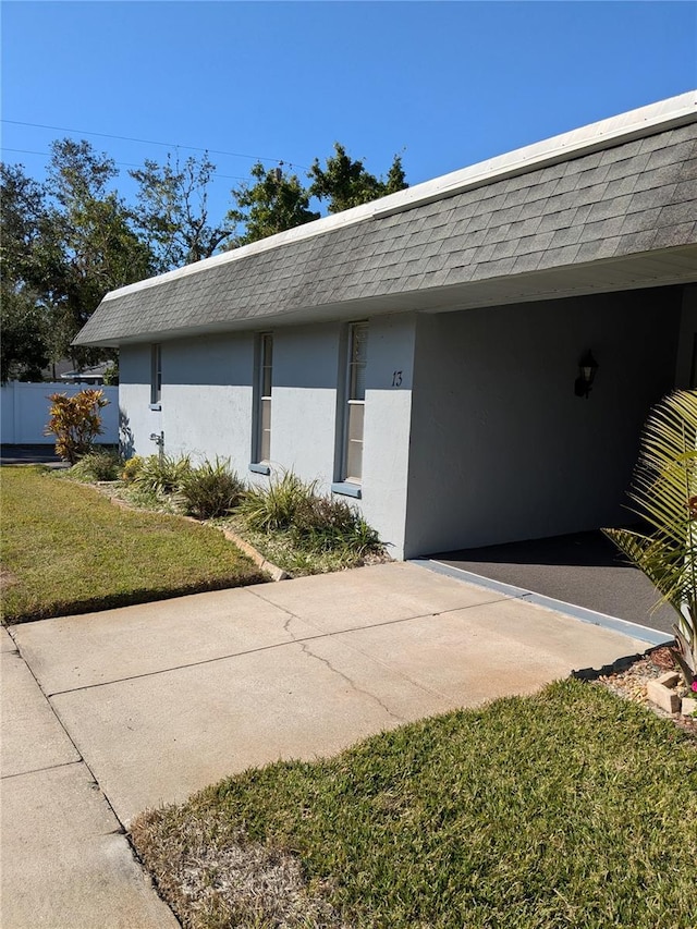 view of side of home with a lawn