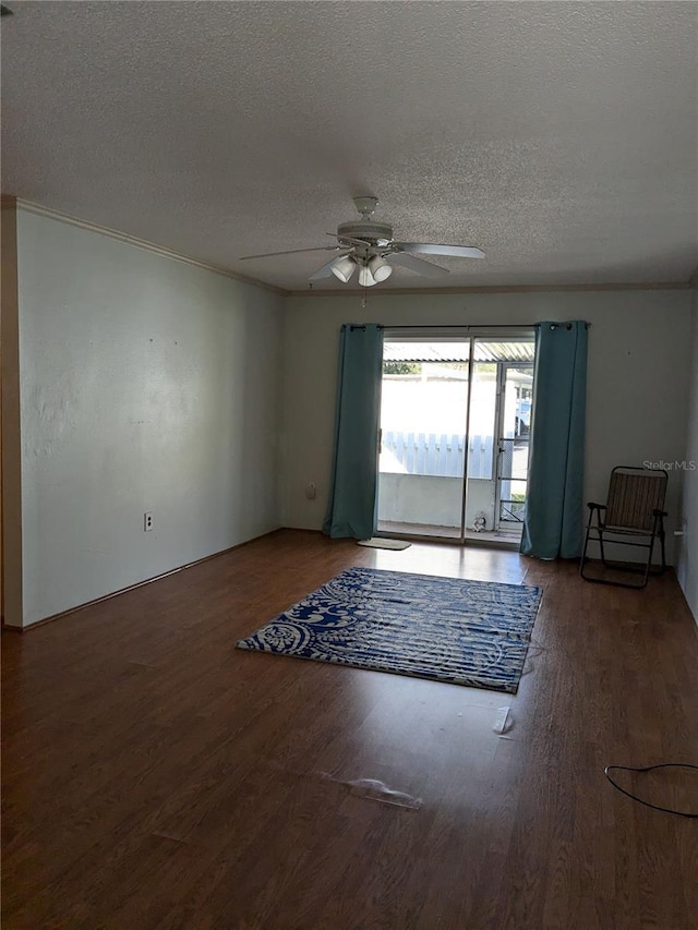 unfurnished room featuring ceiling fan, ornamental molding, dark hardwood / wood-style floors, and a textured ceiling