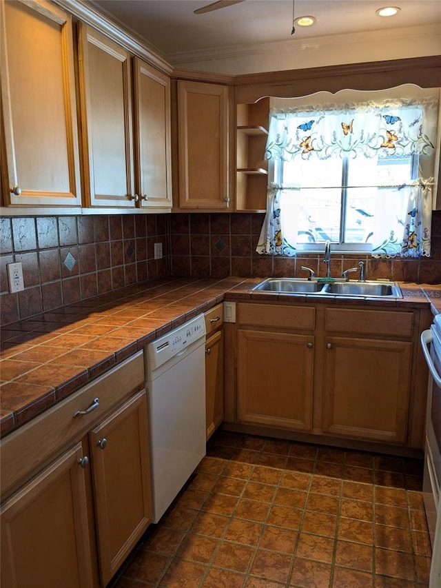 kitchen with sink, white dishwasher, tile countertops, and backsplash