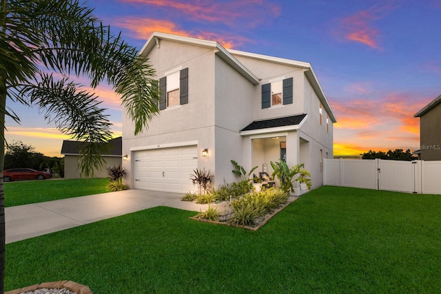 view of front of property featuring a garage and a yard