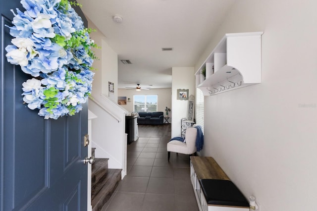 tiled entryway with ceiling fan