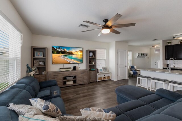 living room with ceiling fan, dark hardwood / wood-style flooring, and a healthy amount of sunlight