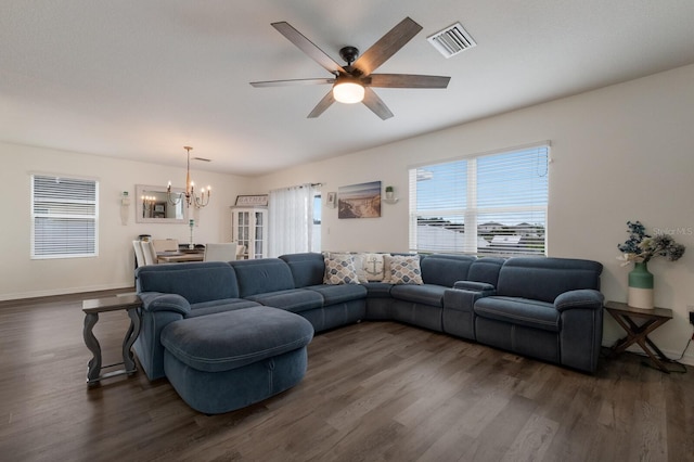 living room featuring dark hardwood / wood-style floors and ceiling fan with notable chandelier