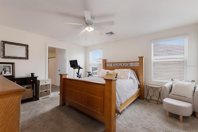 bedroom with carpet flooring, multiple windows, and ceiling fan