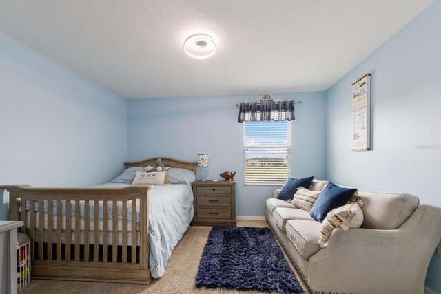 bedroom featuring light carpet