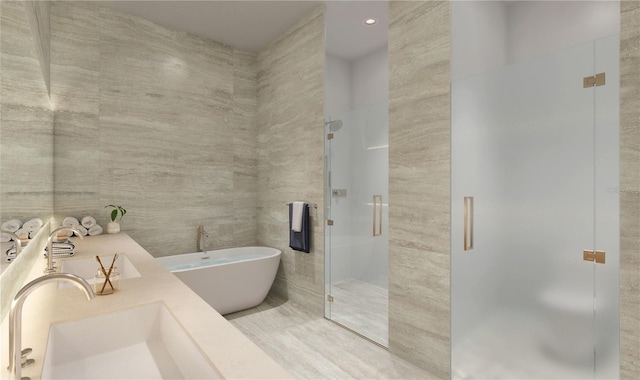 bathroom with sink, separate shower and tub, and tile walls