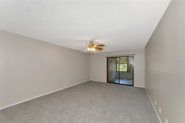 carpeted spare room with ceiling fan and a textured ceiling