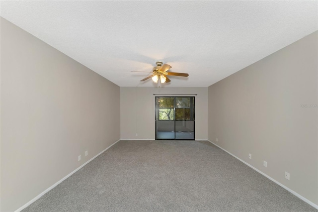 carpeted empty room with a textured ceiling and ceiling fan