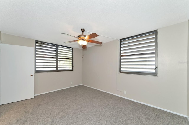 carpeted empty room featuring a textured ceiling and ceiling fan