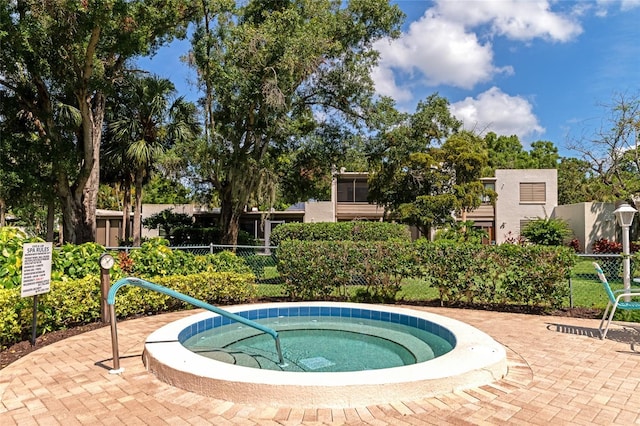 view of pool with a hot tub