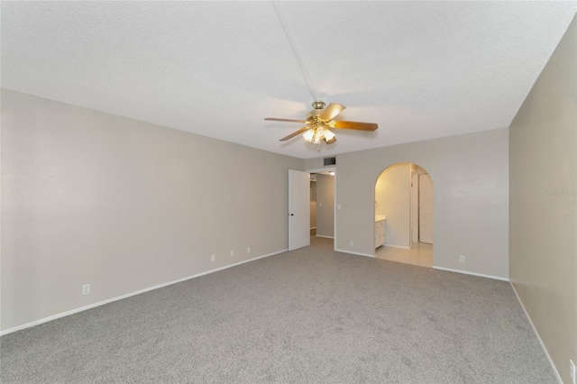 carpeted empty room featuring a textured ceiling and ceiling fan