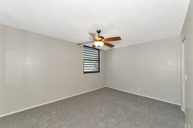 carpeted spare room featuring ceiling fan and a textured ceiling